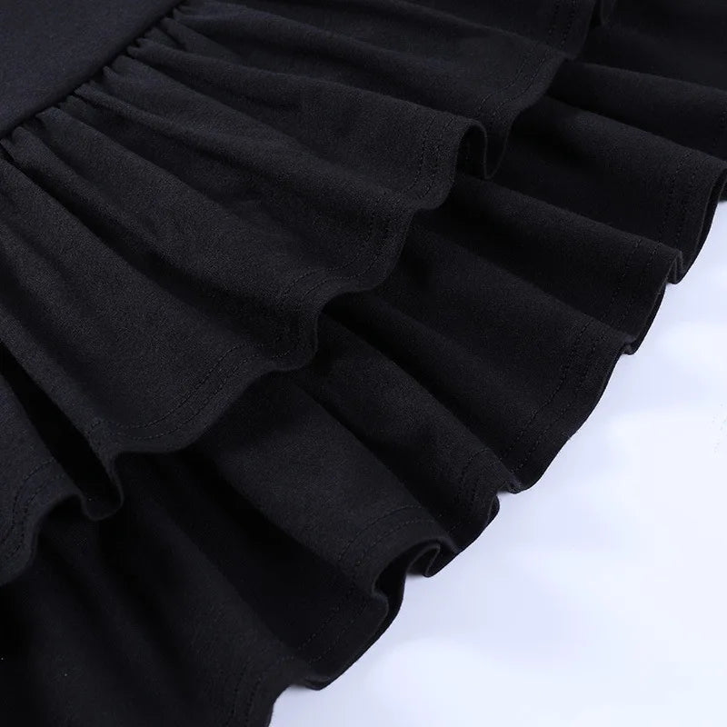 Close view of the black skirt's overlapping gathered ruffles, showing the edges of both tiers.