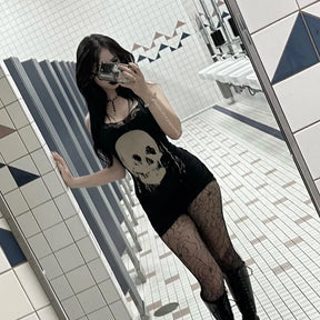 Tilted mirror outfit view of the black skull dress with patterned tights, showing the fitted silhouette and short lace hem.