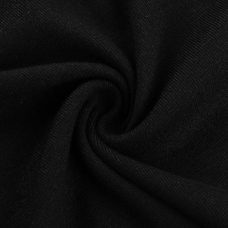 Close view of the black dress fabric gathered into soft folds, showing its fine surface texture.