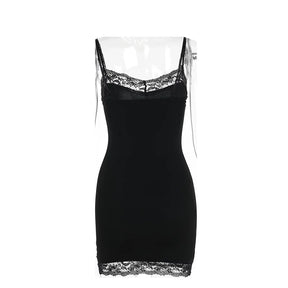 Plain back of the black mini dress isolated on white, showing the lace-trimmed top edge and hem.