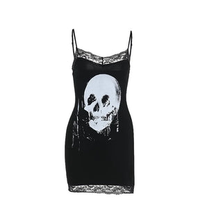 Black skull print mini dress isolated on white, with lace at the neckline and hem and narrow shoulder straps.