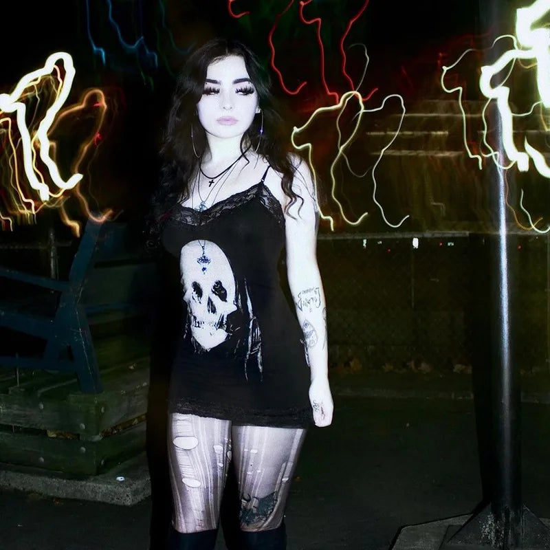 Nighttime front outfit photograph of the black skull lace dress, with the bright skull print visible beneath a dark jacket.