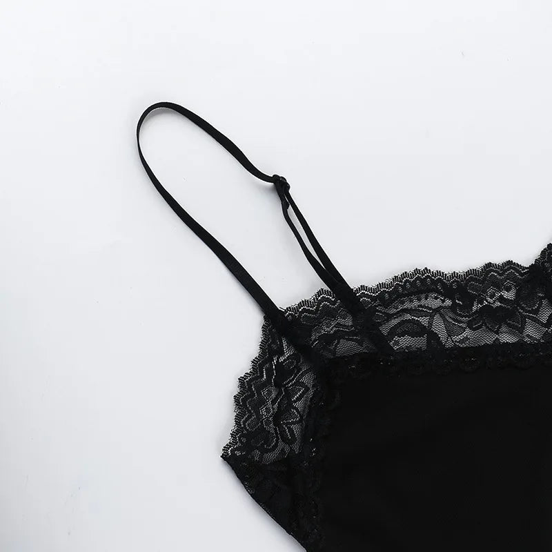 Close-up of a slender shoulder strap and floral lace neckline on the black skull mini dress.