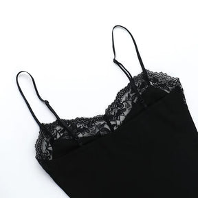 Upper section of the black dress laid flat, showing both slim straps and the lace neckline against white.