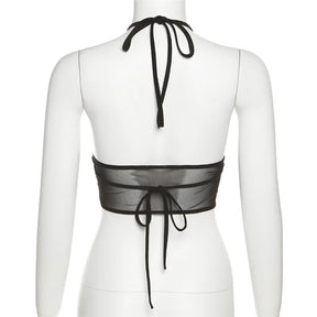 Rear mannequin view of the black halter top, showing the neck bow, sheer back band and long back ties.