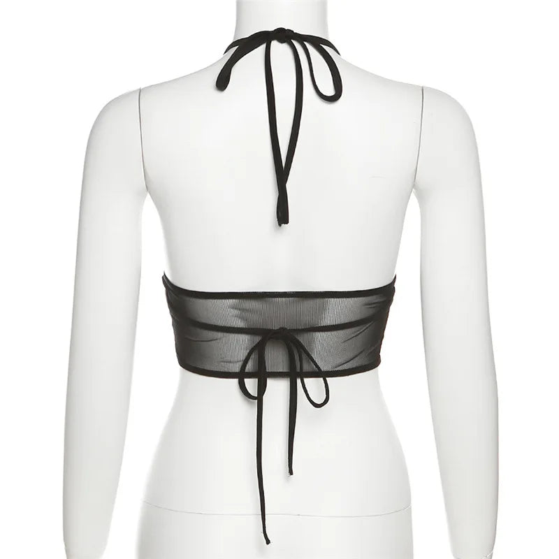 Rear mannequin view of the black halter top, showing the neck bow, sheer back band and long back ties.