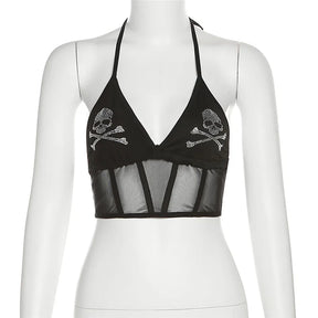 Black skull halter crop top on a white mannequin, showing two sparkling motifs and a sheer mesh lower panel.