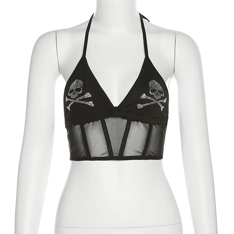 Black skull halter crop top on a white mannequin, showing two sparkling motifs and a sheer mesh lower panel.