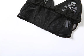 Lower section of the black skull top laid flat, showing transparent mesh panels divided by opaque vertical strips.