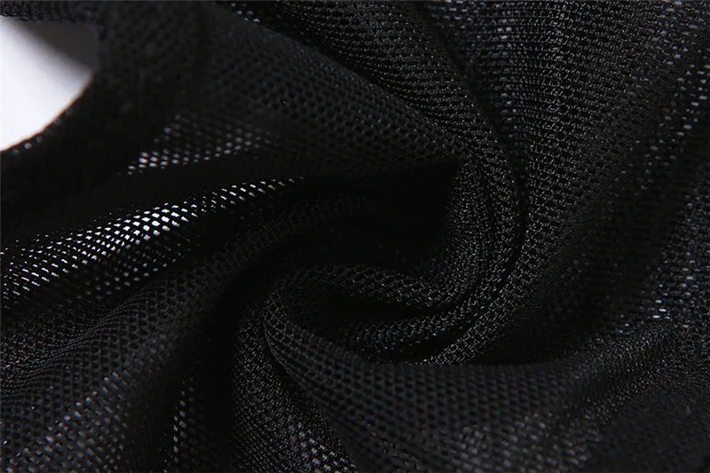 Close-up of the black halter top's fine mesh gathered into folds, showing the open net texture.
