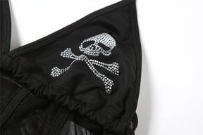 Close-up of a sparkling skull-and-crossbones motif on one black triangular cup, with the gathered lower seam visible.