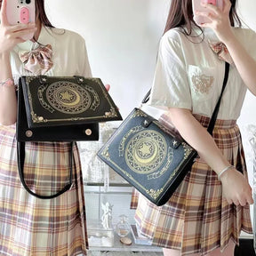 Black spellbook bag showing flap fasteners and shoulder styling