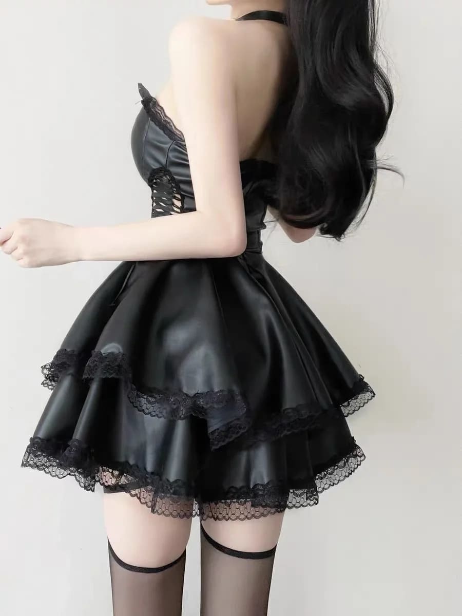 Back view of the black faux leather dress showing its layered ruffle skirt and fitted bodice.