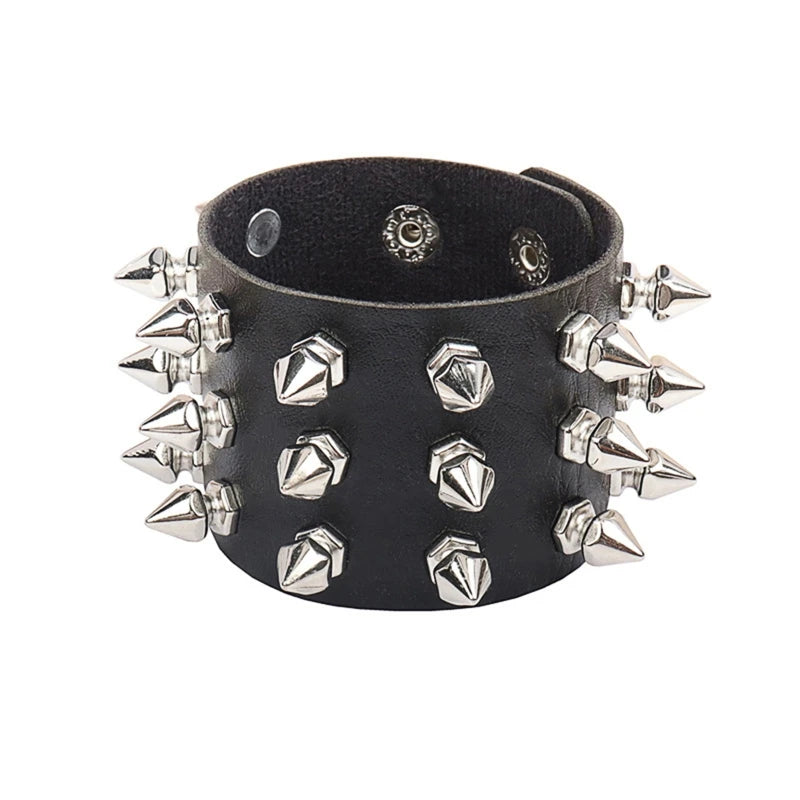 Wide black cuff against white, showing its mixed arrangement of pointed spikes, geometric studs and interior snap closures.