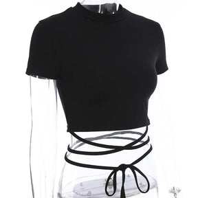Angled mannequin view of the black short sleeve top, showing the cropped hem and wrap ties below it.