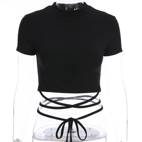 Black round-neck crop top on a clear mannequin, with long ties crossed around the waist and tied at the front.