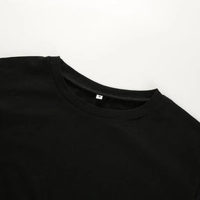 Close flat view of the black crop top's round neckline and plain front panel.