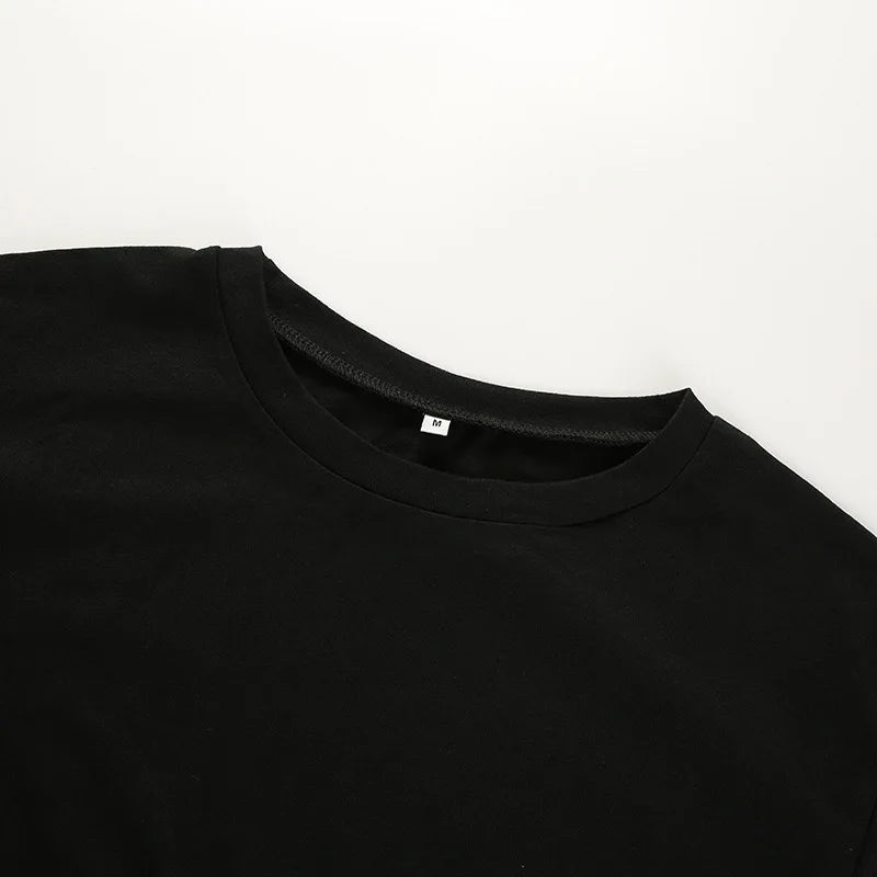Close flat view of the black crop top's round neckline and plain front panel.