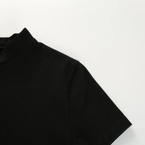 Black crop top laid flat to show the short sleeve shape and shoulder seam.