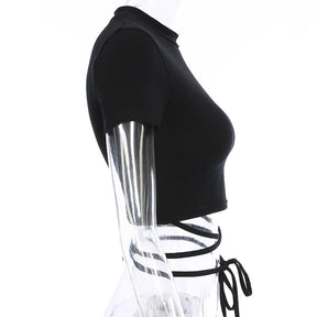 Side mannequin view of the black crop top, showing the short sleeve opening and ties around the waist.