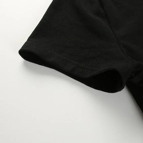 Close-up of the black short sleeve opening and its stitched edge.