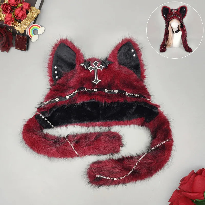 Burgundy plush cat ear hat showing the bat-wing cross, stud details and chain-trimmed ear flaps.
