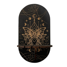 Black Butterfly display shelf with a gold-tone butterfly and geometric linework below hanging crescent and star motifs.