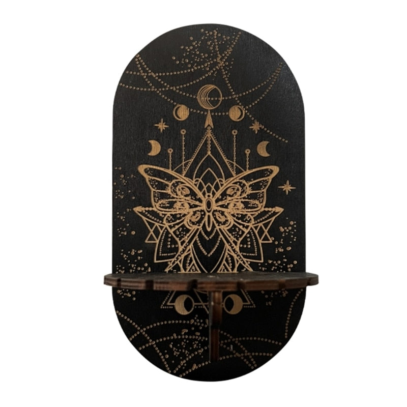 Black Butterfly display shelf with a gold-tone butterfly and geometric linework below hanging crescent and star motifs.