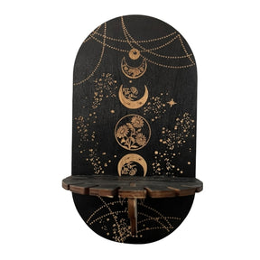 Black display shelf with a vertical sequence of botanical moon circles, gold-tone chain illustrations and a notched front ledge.