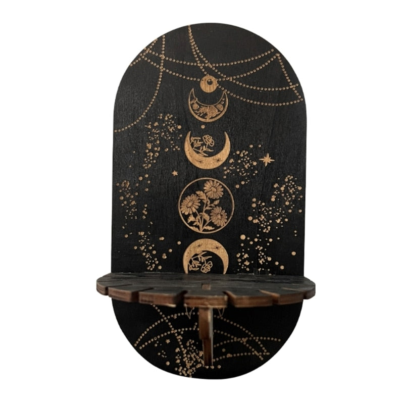 Black display shelf with a vertical sequence of botanical moon circles, gold-tone chain illustrations and a notched front ledge.