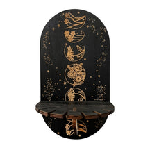 Floral Spheres shelf showing five gold-tone botanical circles down a black arched panel above a small notched ledge.