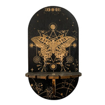 Giant Moth shelf design with a detailed gold-tone moth, geometric lines and small stars printed on a black rounded panel.