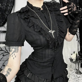 Close-up of gothic ruffle blouse showing puff sleeve and decorative trim