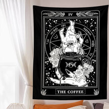 Black-and-white Coffee wall tapestry displayed above a bed, creating a high-contrast card-like focal point beside a window.