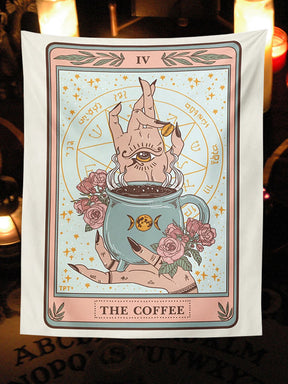 Pastel Coffee tarot-style tapestry displayed in a candlelit corner, with a cup, illustrated hands and roses inside a card-like border.