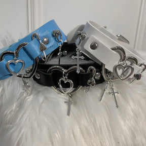 Group photo of white, black and blue display chokers showing silver-tone heart and cross details.