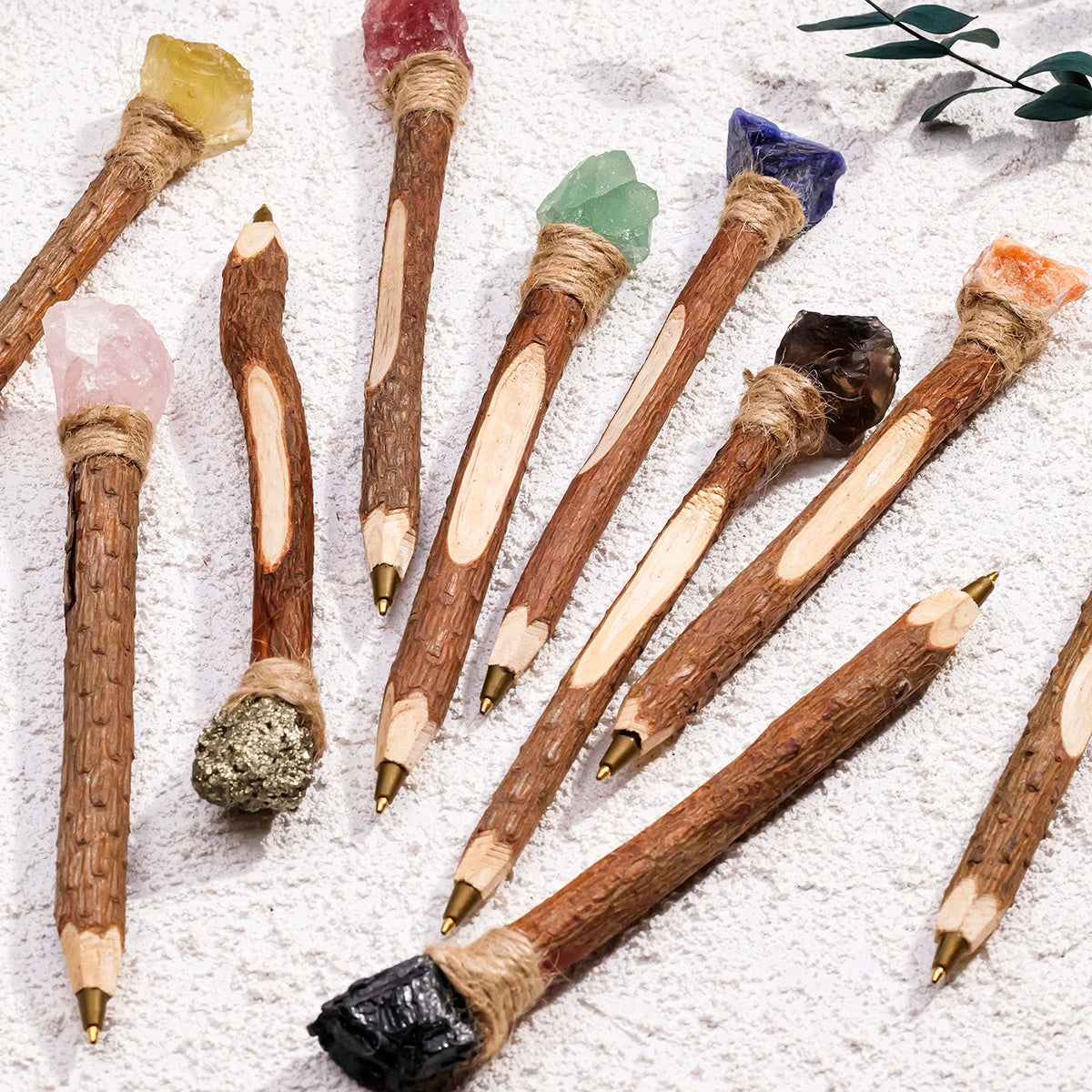 Assorted crystal wand pens showing colorful toppers and wrapped collars