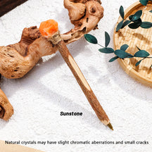 Orange crystal topper on a rustic wand-shaped ballpoint pen