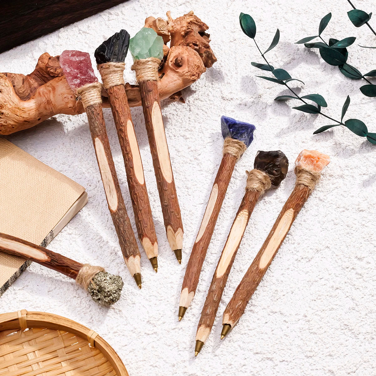 Witchy ballpoint pens arranged with rustic desk decorations