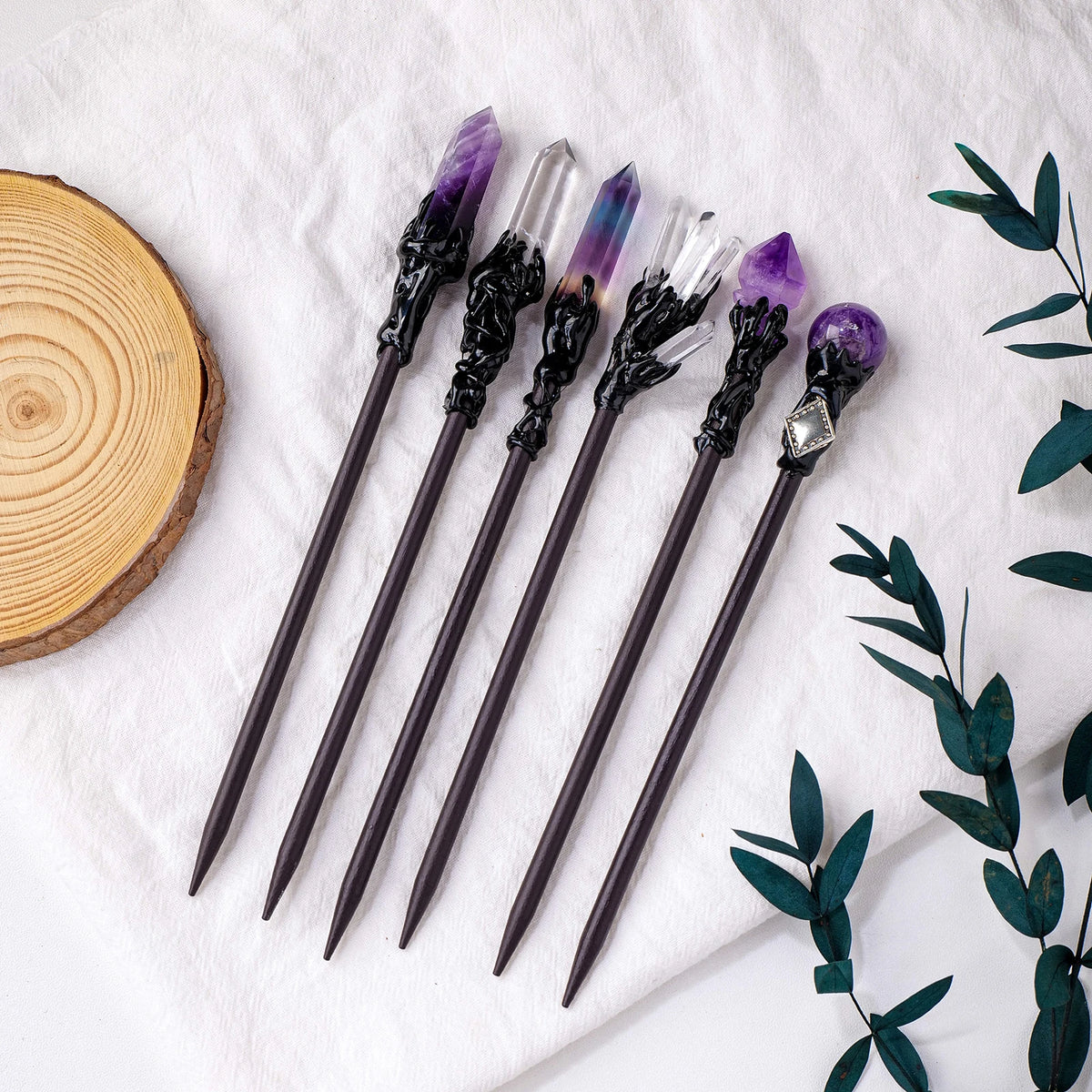 Wand-inspired crystal hair sticks with dark tapered stems and assorted decorative tops