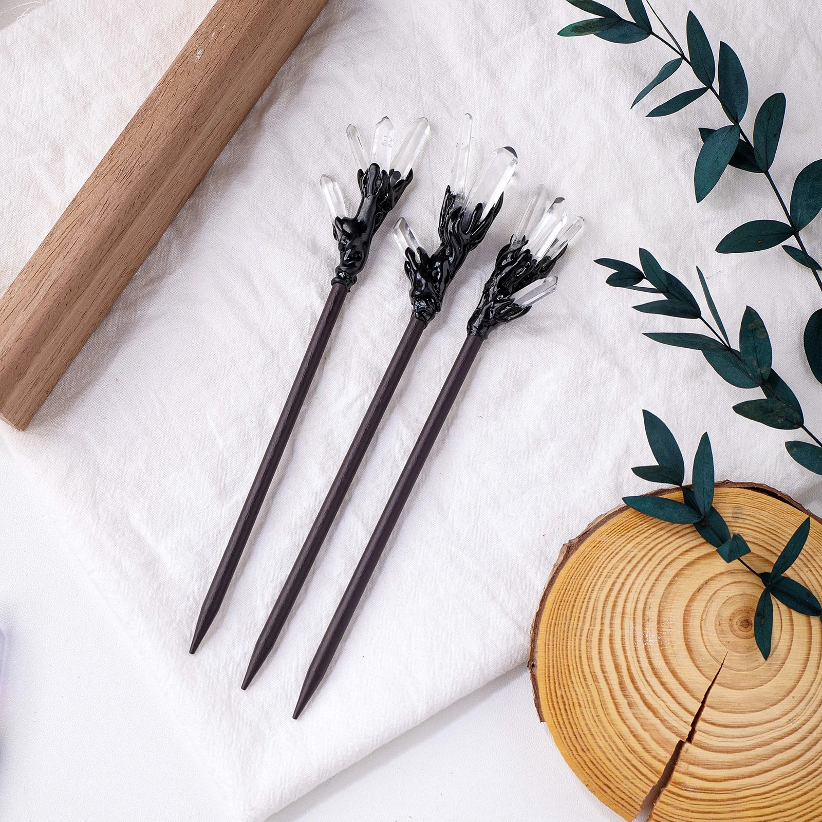 Clear pointed crystal hair sticks with dark sculpted settings and tapered stems