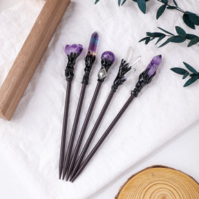 Crystal hair sticks arranged on a pale background with pointed and sphere designs