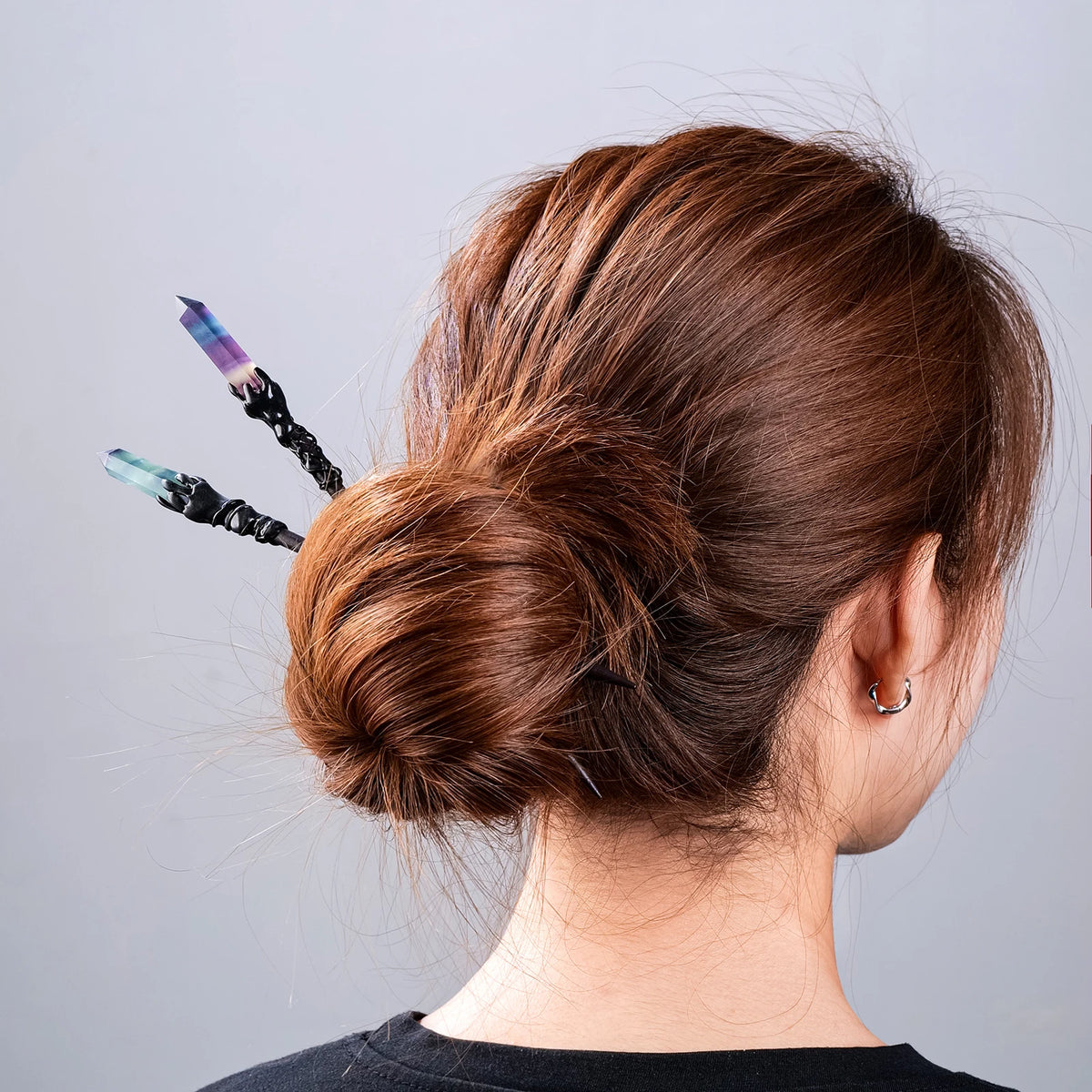 Crystal wand hair sticks styled in a low bun