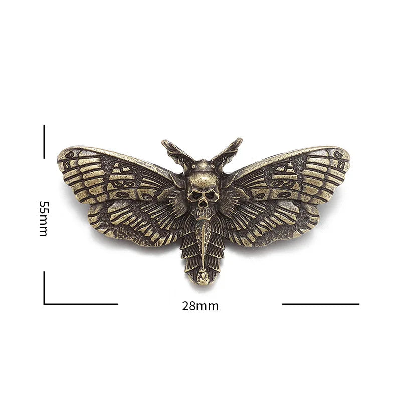 Gold-tone moth brooch isolated on white with supplier measurement annotations around its spread wings.