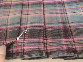 A soft multicolored electric plaid skirt with pink purple teal and black stripes perfect for a school girl look