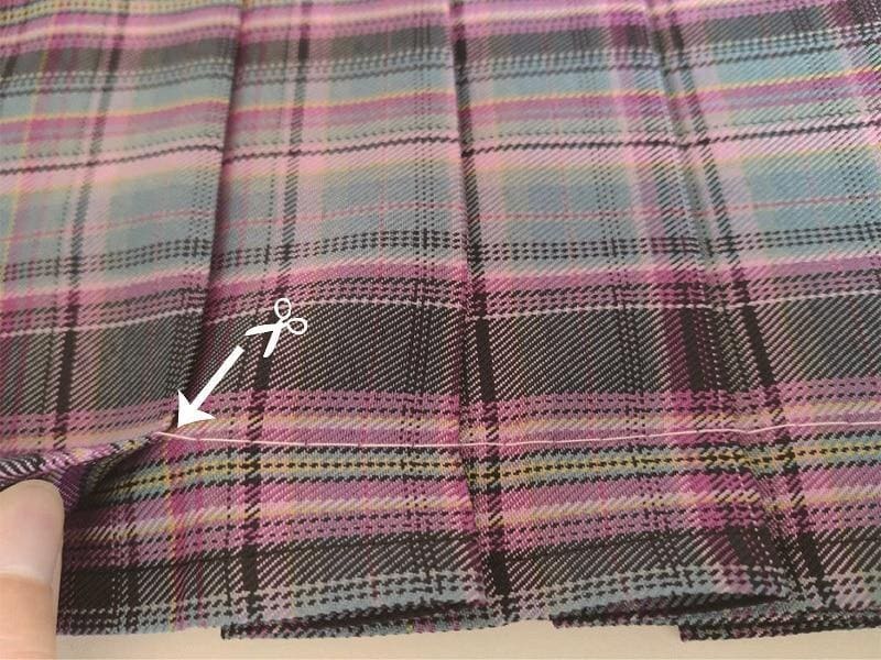 A soft multicolored electric plaid skirt with pink purple teal and black stripes perfect for a school girl look