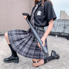 Black plastic baseball bat with matte finish and textured grip shown with electric plaid skirt in 17 color options