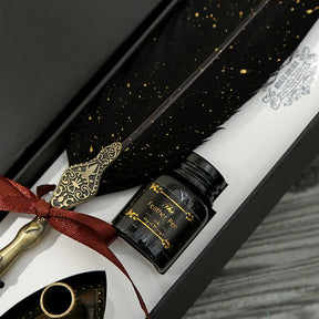 Close view of the black feather, gold-coloured speckles and red ribbon inside the calligraphy pen gift box.