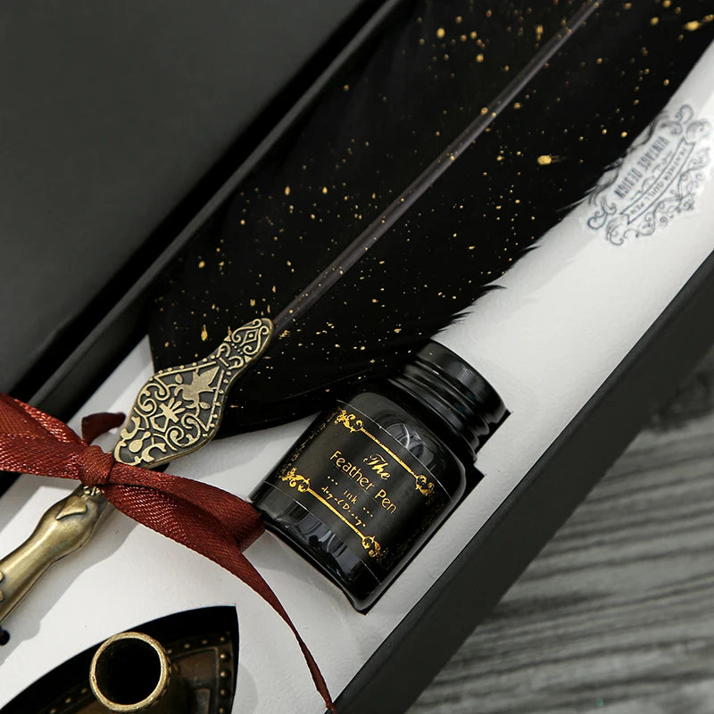 Close view of the black feather, gold-coloured speckles and red ribbon inside the calligraphy pen gift box.