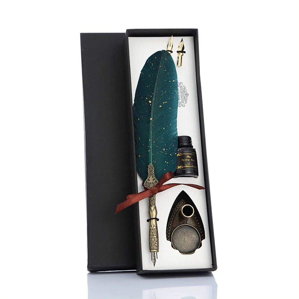 Green feather quill gift set arranged in an open black box with an ornate stand, spare nibs and bottle.